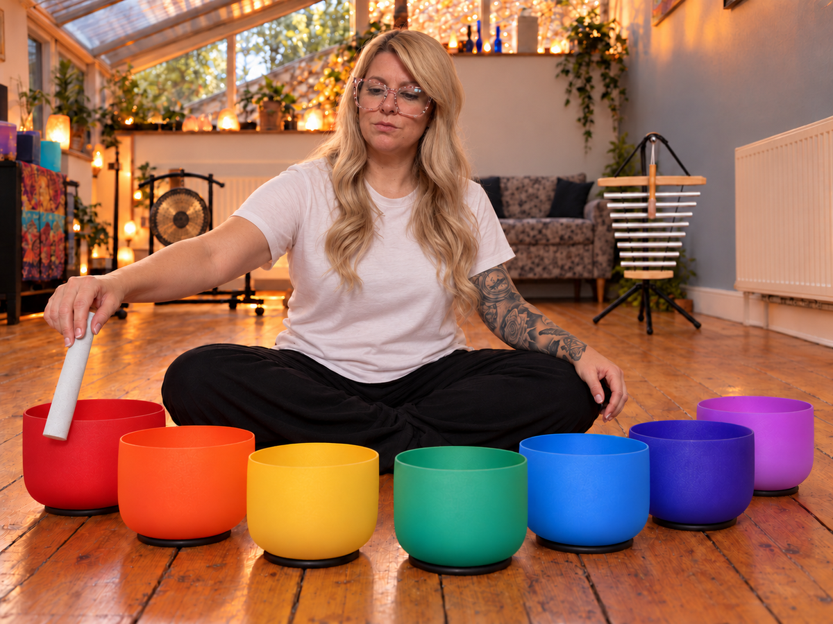 Jenny with colourful sound bowls at The Rising Studio